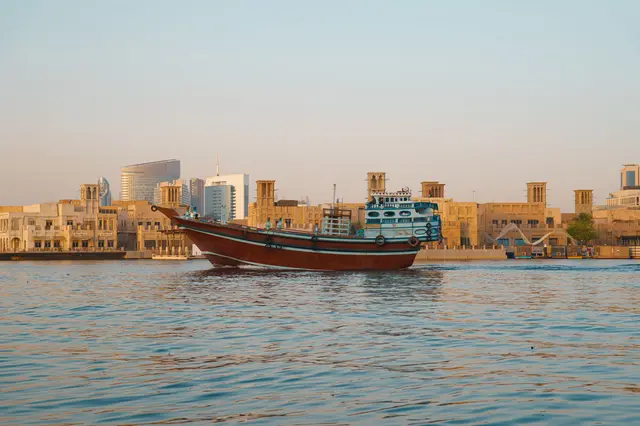 A traditional dhow on Dubai Creek in warm afternoon light