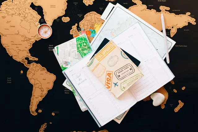 Visa stamps and travel documents on a world map